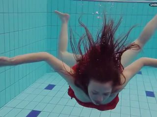 Červený oblečený dospívající plavání s ji oči opened